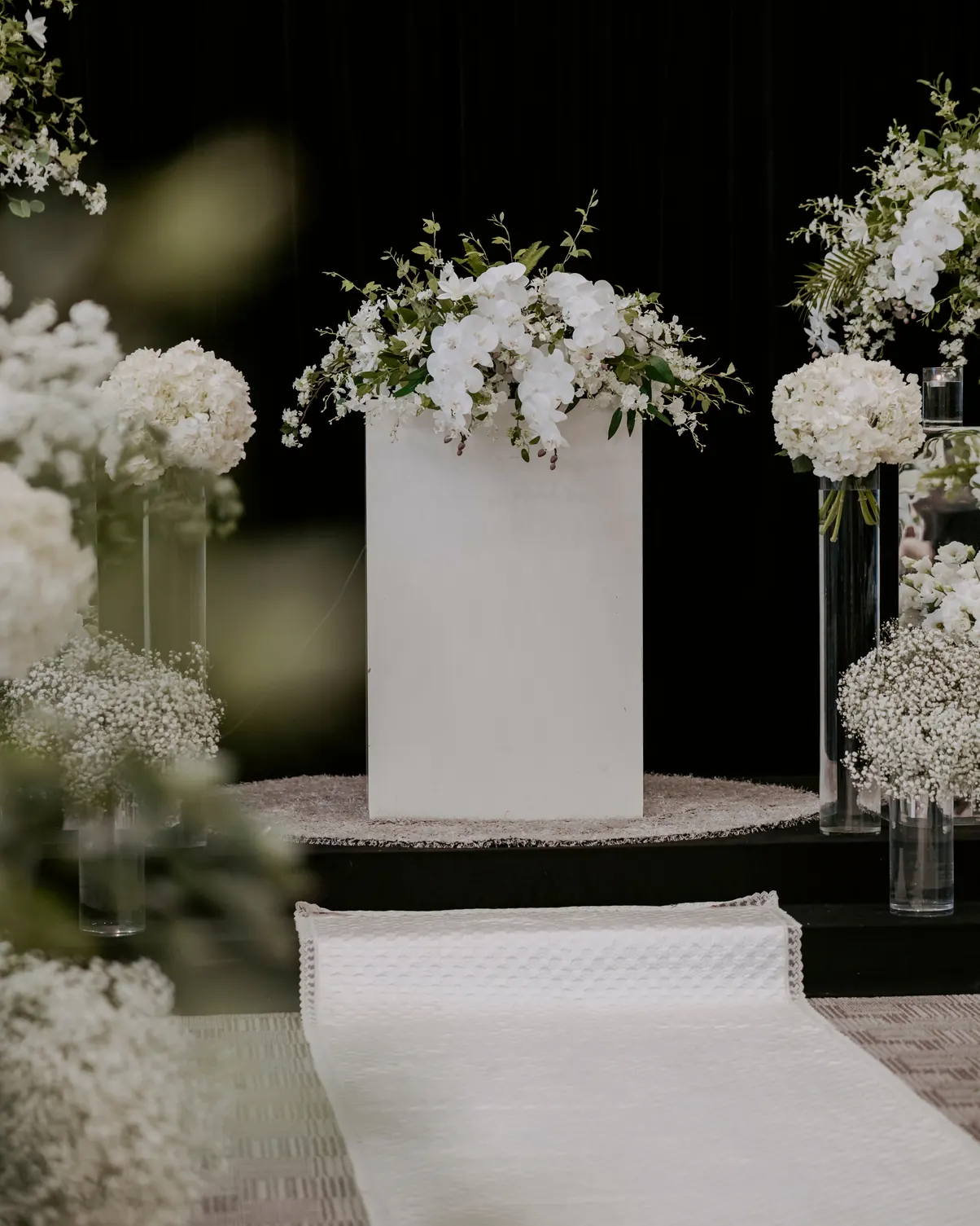White aisle with floral pillars